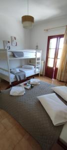 a bedroom with two beds and a large rug at SERENITY Apartments 1 in Vathi, Ithaka