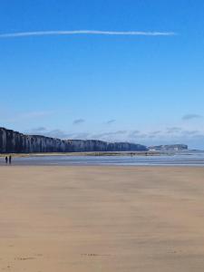 a view of a beach with people walking on the sand at La Durdent - Domaine du Presbytère in La Chapelle-sur-Dun