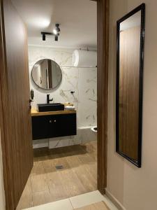 a bathroom with a sink and a mirror at Harmony in Mytilini