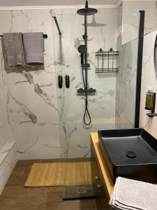 a bathroom with a shower and a sink at Harmony in Mytilene +6 photos