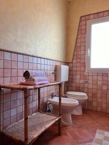 a bathroom with a toilet and a sink at Villa nel centro Salento - Free Wi-Fi in Ruffano +18 photos