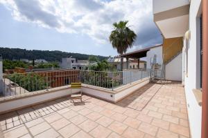 a balcony of a house with a palm tree at Villa nel centro Salento - Free Wi-Fi in Ruffano