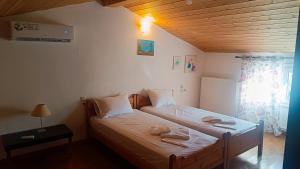a bedroom with two beds with towels on them at Lyra's house in Skiathos Town