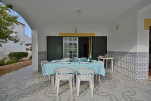 a blue table and chairs on a patio at Villa 3 Quartos, BBQ, Terraço, Praia, Prestige For Home in Castro Marim