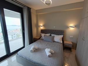 a bedroom with a bed with two towels on it at ALTA MARE in Nea Peramos