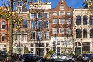 a large brick building with cars parked in front of it at Townhouse 't Raap in Amsterdam