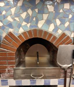 a brick oven with a mosaic tile wall at Vincanto Maiori Costiera Amalfitana in Maiori