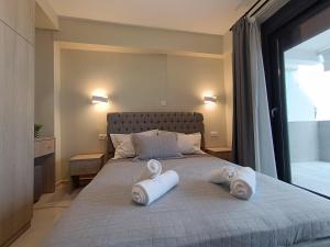a bedroom with a bed with towels on it at ALTA MARE in Nea Peramos