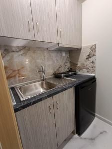 a kitchen with a sink and a counter top at ALTA MARE in Nea Peramos
