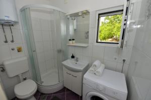 a white bathroom with a sink and a toilet and a shower at House Ana in Banj +43 photos