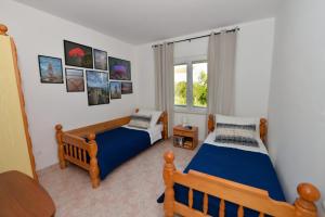 a bedroom with two beds and a window at House Ana in Banj