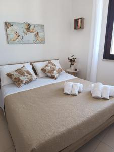 a bedroom with a bed with two pillows on it at La Casa di Aldo e Maria in Marsala