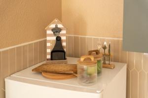 a shelf with bread and a bird house on it at Gite "Douce Campagne" - Terrasse - 3 Chambres - Lits King & Queen size, lits superposés in Saint-Josse +26 photos