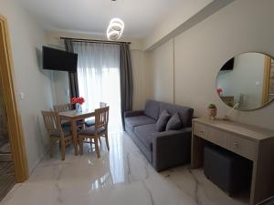 a living room with a couch and a table with a mirror at ALTA MARE in Nea Peramos