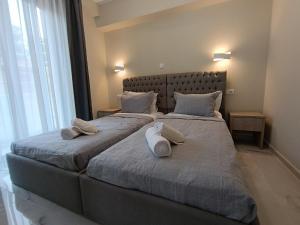 two beds in a bedroom with two pillows on them at ALTA MARE in Nea Peramos