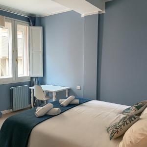 a bedroom with a large bed and a table at Canard Suite in Bologna
