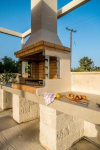 an outdoor oven with a plate of food on a counter at Villa Terra Nuova in Kalyves