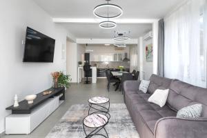 una sala de estar con un sofá y una mesa en House Villa LuNi, en Brodarica