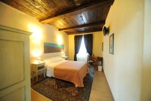 Postel nebo postele na pokoji v ubytování Hotel Il Campanile