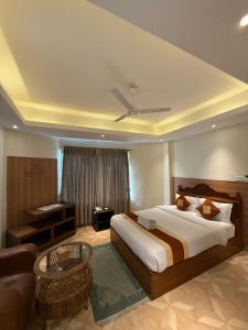 a bedroom with a bed and a living room with a couch at Hotel Middle Path & Spa in Pokhara