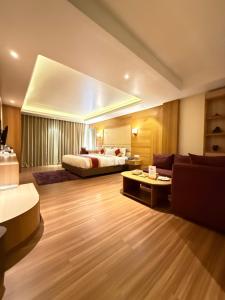 a hotel room with a bed and a couch at Hotel Middle Path & Spa in Pokhara