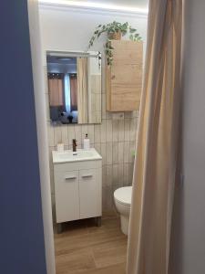a bathroom with a white sink and a toilet at Casa Roberto in Alora +29 photos