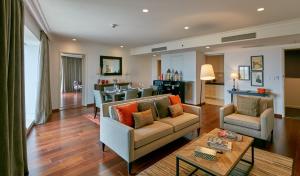 a living room with a couch and a table at The Waverly Hotel & Residences in Bangalore