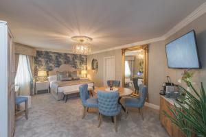 a hotel room with a bed and a table and chairs at Castle Arch Hotel in Trim