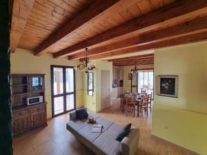 a living room with a couch and a dining room at Villa Veranda Panoramica by Holiday World in Ravanusa