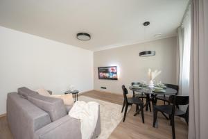 a living room with a couch and a table at Pärnu Pearl Residences in Pärnu