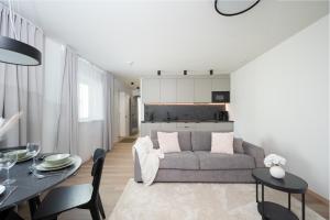 a living room with a couch and a table at Pärnu Pearl Residences in Pärnu