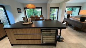 a kitchen and living room with a large island at Chez Max - Terrasse - Climatisation - Parking gratuit in Beaune