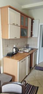 a kitchen with wooden cabinets and a counter top at Tara 1 in Bitola
