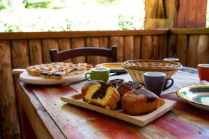 a wooden table with bread and pastries on it at Il Ranch Country House B&B in Anagni +21 photos