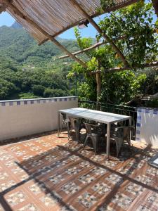 a table and chairs on a patio with a view at Vincanto Maiori Costiera Amalfitana in Maiori