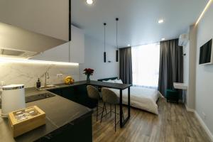 a kitchen with a sink and a bed in a room at VS Apartments in Kyiv