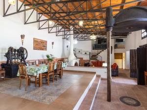 a dining room and living room with a table and chairs at Molino Arroyo in Guájar-Faragüit +31 photos
