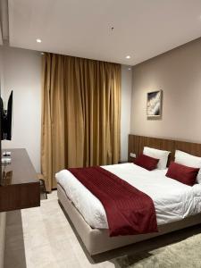 a bedroom with a large bed with red pillows at Pacha hotel in Sfax +20 photos