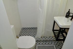 a bathroom with a toilet and a sink at Comfy House in Old Town Xanthi - Meno Homes 8 in Xanthi