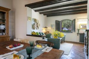 a living room with a table and a couch at Villa Passulunara 14 by Massimo Villas in Collesano