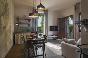 a kitchen and living room with a table and chairs at Villa Passulunara 14 by Massimo Villas in Collesano