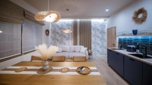 a living room with a white couch and a kitchen at BoKe Prémium Apartmanok in Szarvas