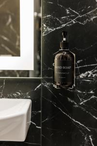 a bathroom with a bottle of hand soap on a counter at VS Apartments in Kyiv +20 photos