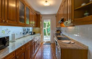 a large kitchen with wooden cabinets and a sink at Villa Gigi by Villas Guide in Poreč