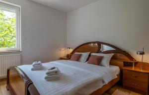 a bedroom with a bed with two towels on it at Villa Gigi by Villas Guide in Poreč +26 photos