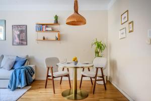 a dining room with a table and chairs and a bed at The Best Apartment in Stylish Sodermalm Stockholm in Stockholm +10 photos