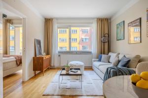 a living room with a couch and a table at The Best Apartment in Stylish Sodermalm Stockholm in Stockholm