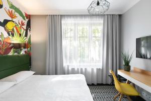 Postel nebo postele na pokoji v ubytování Liv'Inn Aparthotel