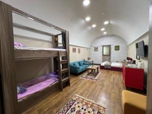 a room with two bunk beds and a couch at Old Baku Apartment in Baku
