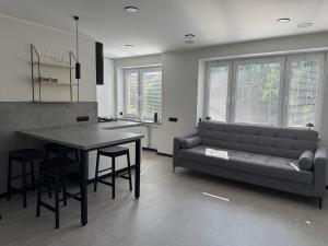 a living room with a couch and a table at New modern apartments in the centre in Narva +13 photos